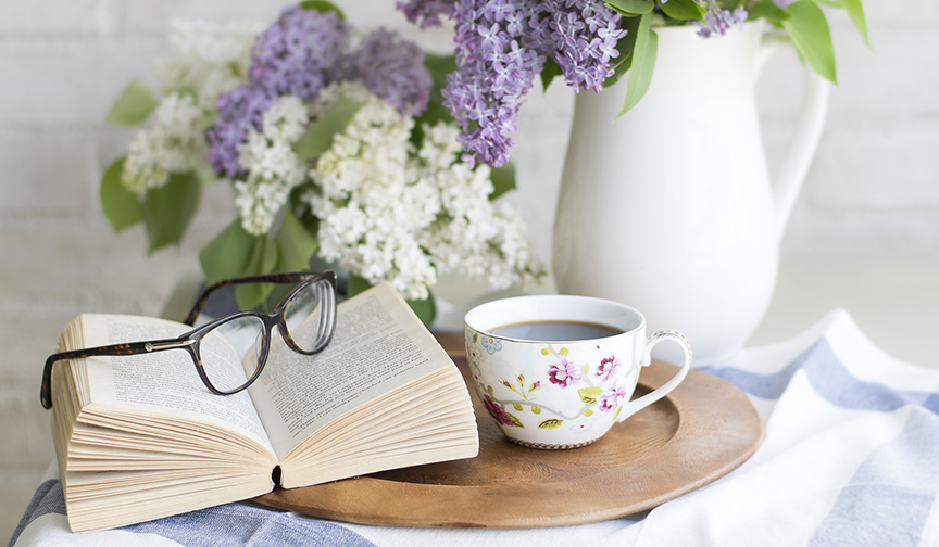 Book open with morning tea and flowers