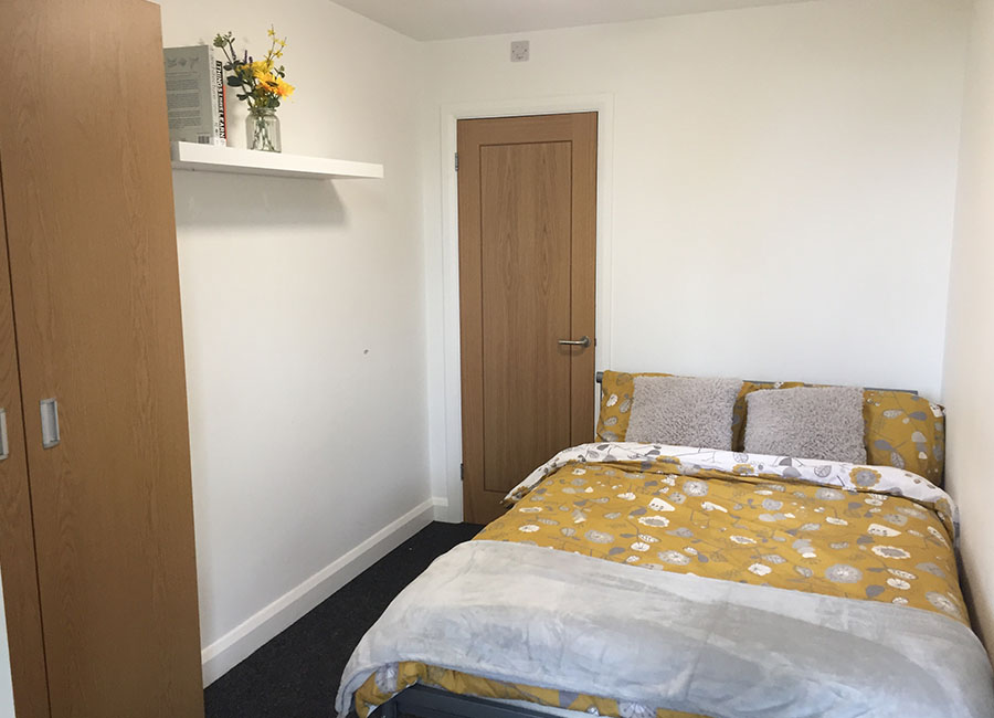 Student Accommodation in Leicester - Large seating area and TV on wall